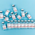 vaccine bottles on blue background